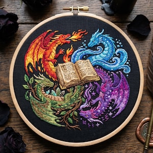 May include: A circular embroidery hoop containing black fabric with a hand-stitched design of four dragons surrounding an open book. The dragons are colored red, blue, green, and purple, representing fire, water, earth, and magic elements.