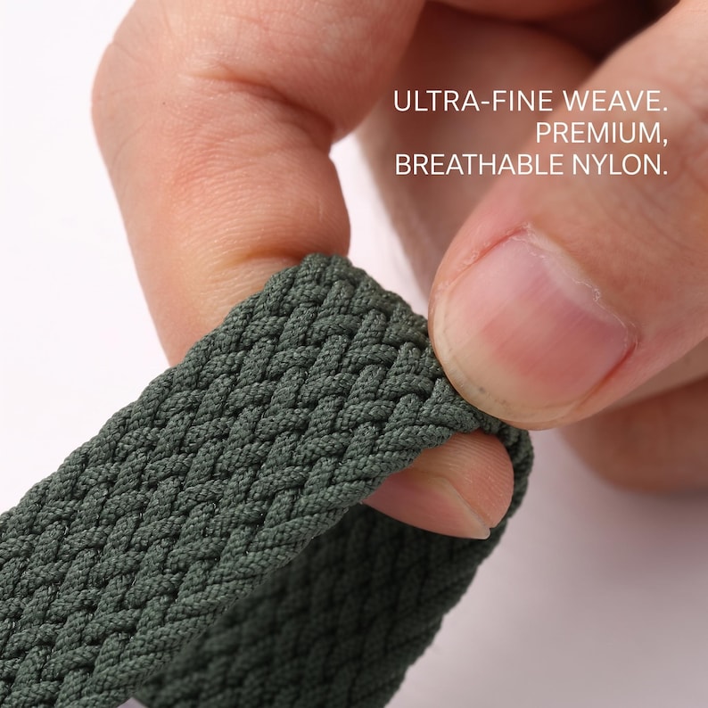 May include: A dark olive green nylon strap featuring an ultra-fine weave pattern. The material is described as premium, breathable nylon. The strap has a textured, braided appearance with a consistent, dense construction throughout the visible surface.