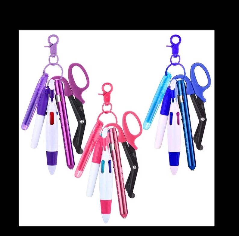 Puede incluir: Tres llaveros con bol&iacute;grafos y tijeras. Cada llavero tiene una combinaci&oacute;n de colores diferente: morado, rosa y azul. Los bol&iacute;grafos son multicolores y las tijeras son negras y del color a juego con el llavero.