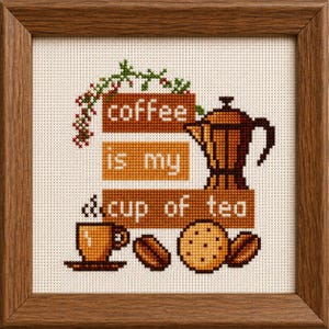 May include: A framed cross-stitch embroidery on cream fabric featuring a brown moka pot, a coffee cup, a cookie, and two coffee beans. The text reads "coffee is my cup of tea" in white letters on three brown rectangular blocks with green foliage.