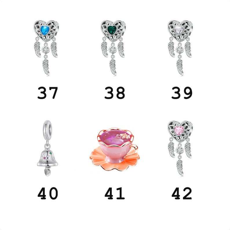 May include: A collection of silver charms including four heart-shaped dreamcatcher designs with blue, green, clear, and pink stones, a bell charm with colorful accents, and a pink teacup on a saucer, labeled with numbers 37 through 42.