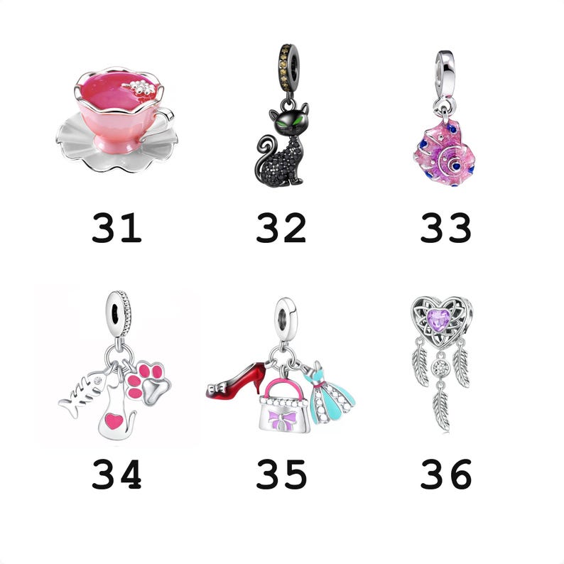 May include: A collection of six silver charms labeled 31 through 36. The charms feature a pink teacup, a black cat, a pink seashell, a fish bone with a cat and paw print, a red shoe with a handbag and dress, and a heart-shaped dreamcatcher.