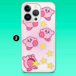May include: Clear phone case featuring a pink background with cartoon pink characters and yellow stars. The phone case has a clear border and a camera cutout. The number "2" is printed in black on the case.
