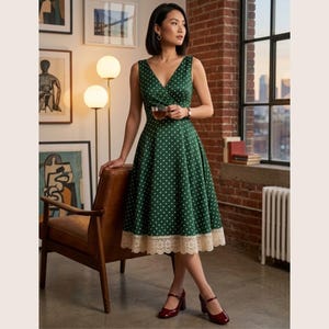 May include: A sleeveless, forest green midi dress featuring a white polka dot pattern, a V-neckline, and a fitted bodice that flares at the waist. The hem is finished with a wide, cream-colored lace trim. The dress has a classic silhouette.