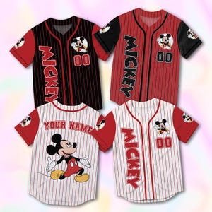 May include: Four baseball jerseys featuring Mickey Mouse. Two jerseys are red and black, with "Mickey" printed vertically. The other two are white with red pinstripes, one with "Your Name" and the other with "Mickey". Each jersey has the number "00".