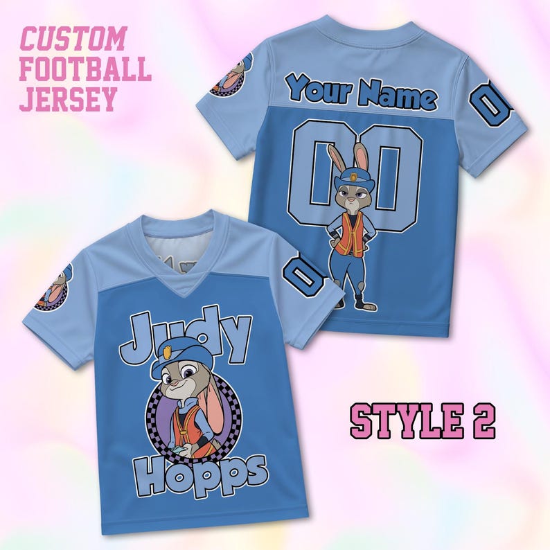 May include: Two light and medium blue custom football jerseys featuring a graphic of Judy Hopps in a police uniform. The front displays the name Judy Hopps, while the back includes the text Your Name and the number 00. Both shirts have short sleeves.