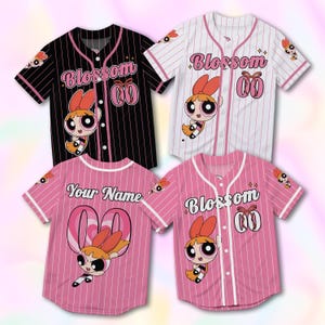 May include: Four baseball jerseys in black, white, and pink, each featuring a cartoon character and the word "Blossom" or "Your Name". The jerseys have a button-up front, short sleeves, and a striped pattern.