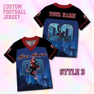 May include: A custom football jersey featuring a black and blue city skyline graphic with Miles Morales, the text "Miles Morales" and "00" on the front, and "YOUR NAME" with "00" on the back. The shirt has a red V-neck collar and red sleeve trim.