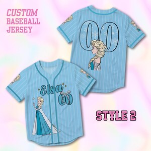May include: Light blue custom baseball jersey with white pinstripes, featuring Elsa from Frozen. The jersey has the name "Elsa" and the number "00" on the front and back. The text "CUSTOM BASEBALL JERSEY" and "STYLE 2" are also visible.