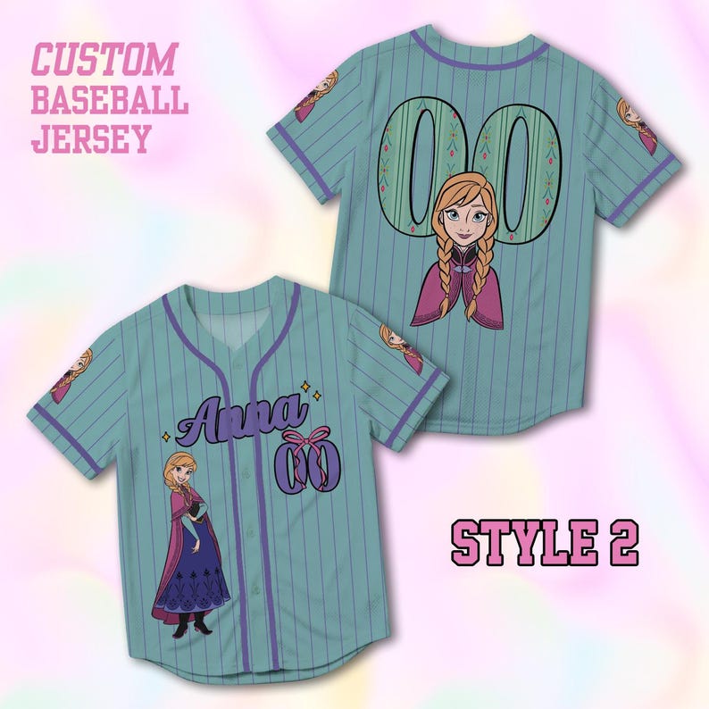 May include: Two light blue baseball jerseys with purple pinstripes and accents. One jersey features the name "Anna" and the number "00" with a bow graphic. The other jersey has the number "00" on the back. Both jerseys have an image of a cartoon character.