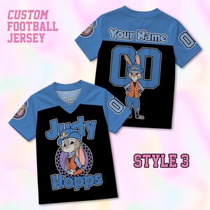 May include: A custom football jersey featuring a blue and black color scheme. The front displays a graphic of Judy Hopps with the text Judy Hopps. The back includes the text Your Name above the number 00 and a full-body graphic of Judy Hopps.