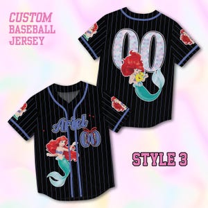May include: Black pinstripe baseball jersey featuring Ariel from The Little Mermaid. The jersey displays the name "Ariel" and the number "00". Blue trim accents the sleeves and collar. The text "CUSTOM BASEBALL JERSEY" and "STYLE 3" are also visible on the image.