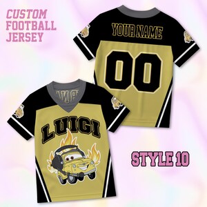 May include: A custom football jersey in black and gold featuring a V-neck collar. The front displays the name LUIGI above a yellow car character with flames. The back shows the text YOUR NAME and the number 00 in black with gold outlines.