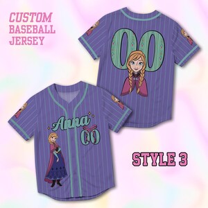 May include: Purple baseball jersey with vertical white stripes and a teal collar and sleeve trim. The jersey features the name "Anna" and the number "00" with a cartoon image of a character. The text "CUSTOM BASEBALL JERSEY" is at the top.