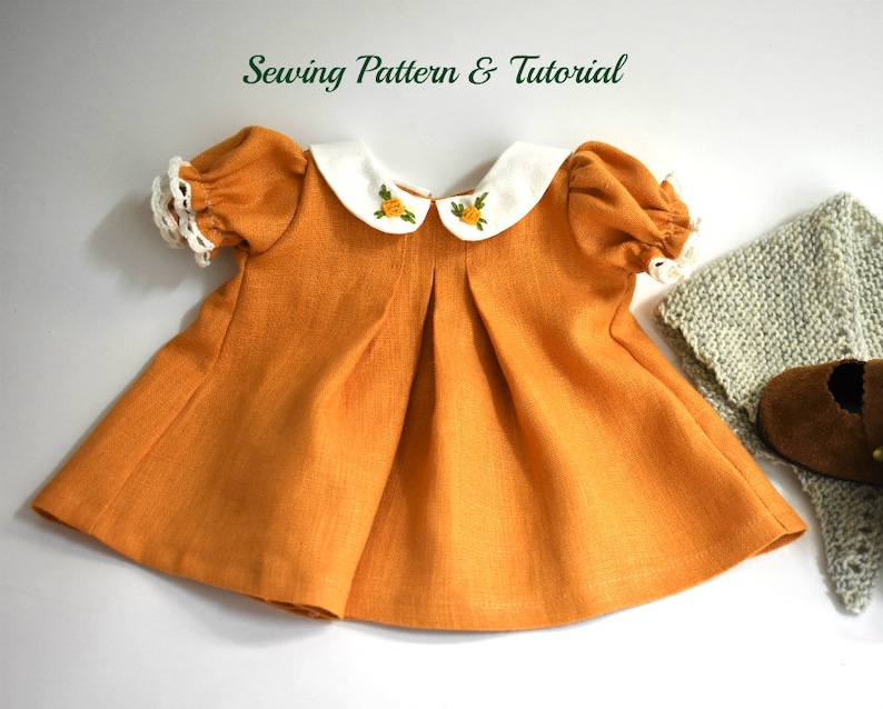 PDF sewing pattern and tutorial for vintage-style doll dress with puff sleeves and floral embroidered collar. Fits 18-20 inch Waldorf dolls. Elegant and classic look.