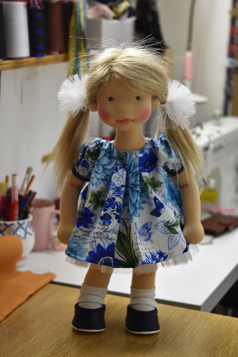 PDF sewing pattern and tutorial for vintage-style doll dress with puff sleeves and floral embroidered collar. Fits 18-20 inch Waldorf dolls. Elegant and classic look.