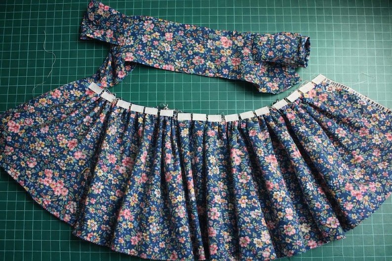 Summer doll clothes sewing pattern set for Waldorf dolls, includes linen romper, white ruffle blouse, denim pants, floral dress, and lace-trimmed playsuit. Handmade doll outfit tutorial, PDF download, perfect for 15-18 inch dolls and DIY doll wardrobes