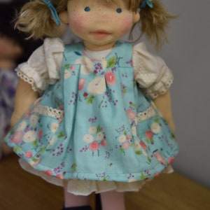 PDF sewing pattern and tutorial for vintage-style doll dress with puff sleeves and floral embroidered collar. Fits 18-20 inch Waldorf dolls. Elegant and classic look.