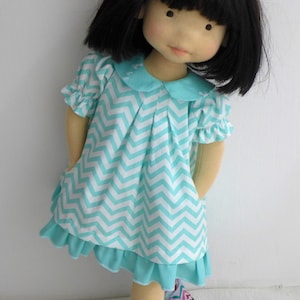 PDF sewing pattern and tutorial for vintage-style doll dress with puff sleeves and floral embroidered collar. Fits 18-20 inch Waldorf dolls. Elegant and classic look.