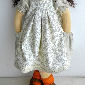 PDF sewing pattern and tutorial for vintage-style doll dress with puff sleeves and floral embroidered collar. Fits 18-20 inch Waldorf dolls. Elegant and classic look.