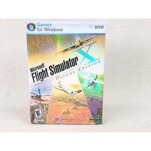May include: A Microsoft Flight Simulator X Deluxe Edition PC DVD game case featuring a white airplane flying over desert pyramids, a helicopter, and a seaplane. The cover includes the Games for Windows logo, the ESRB E rating, and Microsoft branding.