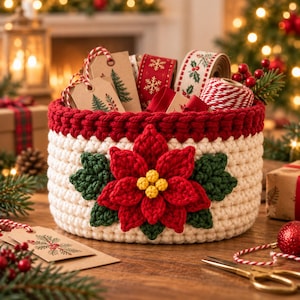 May include: A round, cream-colored crocheted basket with a thick red rim, featuring a large, three-dimensional red poinsettia flower with green leaves on the front. The basket is filled with various ribbons, gift tags, and twine.