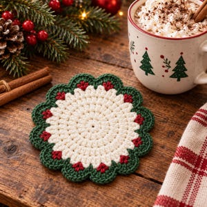 May include: A round, crocheted coaster featuring a cream-colored center with a scalloped border in dark green. The border is accented with small, red, petal-like stitches at each scallop point, creating a circular, floral-inspired design.