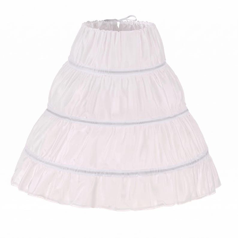 May include: A white petticoat with three tiers, each accented with a thin, light gray trim. The petticoat has a gathered waist and a flared silhouette, designed to add volume to a skirt or dress. The fabric appears lightweight and slightly translucent.