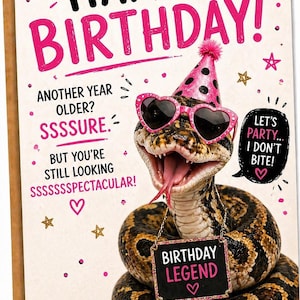 May include: Birthday card featuring a snake wearing heart-shaped sunglasses and a party hat. The card has the words "HAPPY BIRTHDAY!" in pink and black, with additional text and a "BIRTHDAY LEGEND" sign.