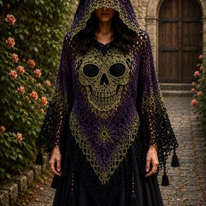 May include: A hooded crochet poncho featuring a large skull motif in shades of black, purple, and olive green. The garment has an open-weave pattern, a pointed hemline, and decorative black tassels hanging from the edges and the centre point.