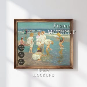 May include: A rectangular wooden frame containing a painting of children playing in the ocean surf. The artwork depicts figures in light-colored clothing wading in shallow water. Text overlays include "Frame MOCKUP", "Smart Object", "PSD File", and "5:4 Ratio".