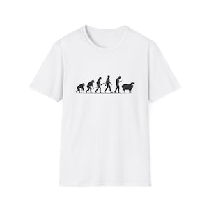 May include: A white short-sleeved t-shirt featuring a black graphic print of the human evolution sequence, starting with a primate and ending with a human figure looking at a phone, followed by a sheep wearing a face mask on the far right side.