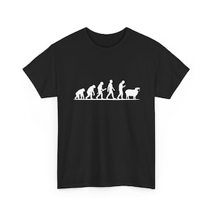 May include: A black short-sleeved t-shirt featuring a white graphic print of the evolution of humans, starting with a primate and ending with a human looking at a phone, followed by a sheep wearing a face mask, all aligned on a horizontal line.