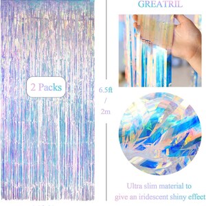 May include: Two packs of iridescent fringe curtains measuring 6.5 feet by 3.2 feet. The material is ultra-slim and creates a shiny, reflective effect with blue, pink, and silver tones. The brand name GREATRIL is visible at the top of the image.