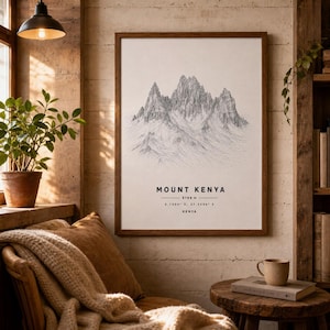May include: A framed wall art print featuring a detailed black and white line drawing of Mount Kenya. The text below the mountain illustration reads MOUNT KENYA, 5199 m, 0.1500 S, 37.3556 E, and KENYA, presented in a clean, minimalist sans-serif font.