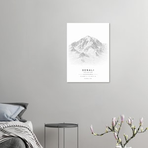 May include: A vertical wall art print featuring a detailed black and white line drawing of Denali mountain. The text reads DENALI, THE HIGH ONE, 20,310 ft (6,190 m), 63.0695° N, 151.0074° W, ALASKA, USA, centered below the mountain illustration.
