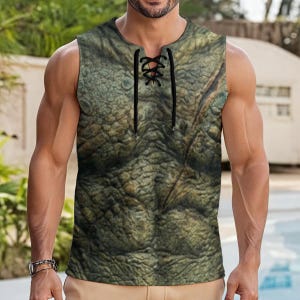 May include: A sleeveless shirt featuring a realistic green and brown textured reptile skin pattern. The garment has a round neckline with a vertical slit down the centre, secured by thin black laces that crisscross through metal eyelets.
