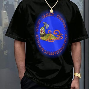 Può includere: Una t-shirt nera con una grafica ovale blu al centro. All'interno dell'ovale c'è una lumaca verde con naso rosso, collare borchiato e un'ascia conficcata nella testa, circondata da bava arancione. Il testo recita: UNITY, FAMILY, SUPPORT, AND KNEECAPPING BITCHES!
