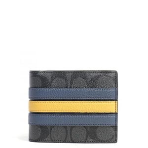 May include: A bifold wallet featuring a black and charcoal gray signature monogram pattern. The front is accented with two horizontal blue leather stripes and a central horizontal yellow leather stripe, creating a distinct color-blocked design.