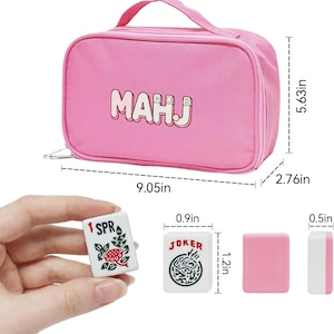 May include: Pink Mahjong set with a matching carrying case. The case measures 9.05 inches long, 5.63 inches high, and 2.76 inches wide. The set includes tiles with the text "MAHJ", "1 SPR", and "JOKER".