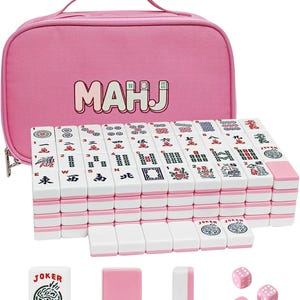 May include: A pink Mahjong set with white and pink tiles, dice, and accessories. The set includes a pink carrying case with the word "MAHJ" printed on it. The tiles are arranged in a stack, with some tiles and accessories placed in front.