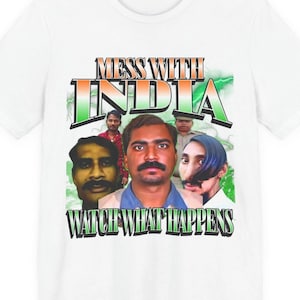 May include: A white t-shirt featuring a graphic print with the text MESS WITH INDIA at the top and WATCH WHAT HAPPENS at the bottom. The design includes a collage of four individuals against a green lightning background with a color palette of orange, white, and green.