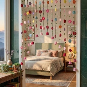 Peut inclure: Un rideau de porte décoratif composé de multiples brins crochetés verts verticaux suspendus à une tringle horizontale. Chaque brin est orné de petites fleurs crochetées colorées et de fleurs en forme de cloche dans des tons rouge, rose, jaune et bleu.