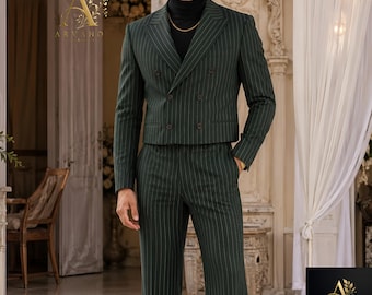 May include: A dark green double-breasted suit with thin white pinstripes, featuring a cropped blazer with notched lapels and matching high-waisted trousers. The suit is worn over a black turtleneck jumper. The Arvano logo is visible in the corner.