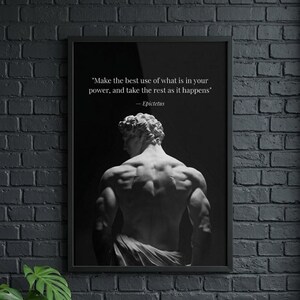 May include: A black framed wall art print featuring a monochromatic image of a muscular statue seen from behind. Above the statue, the text reads: "Make the best use of what is in your power, and take the rest as it happens" — Epictetus.