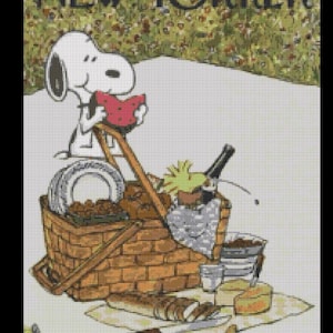 May include: A cross-stitch pattern of a New Yorker magazine cover featuring Snoopy eating a slice of watermelon next to a picnic basket filled with food, a bottle, and plates, with a loaf of bread and cheese on a checkered cloth in the foreground.