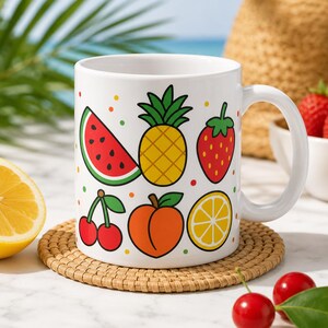 May include: A white ceramic mug featuring a colorful pattern of various fruits including a watermelon slice, a pineapple, a strawberry, a pair of cherries, a peach, and a lemon slice, all arranged against a clean white background.