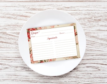 May include: A blank recipe card with a floral design featuring red and white roses. The card has lines for writing the recipe name, ingredients, and serving size.