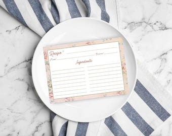 May include: A pink and white recipe card with floral accents. The card has lines for writing down the recipe name, time, servings, and ingredients.