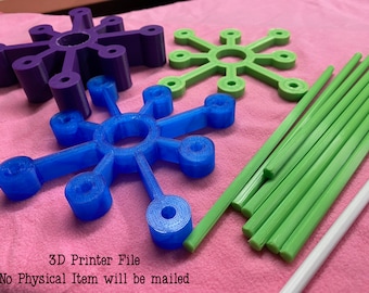 May include: A collection of 3D-printed snowflake-shaped ornaments in purple, blue, and green, along with green and white rods. The text "3D Printer File" and "No Physical Item will be mailed" is visible.